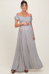 woman wearing a striped off-shoulder maxi maternity dress and showing her baby bump