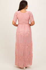 maternity wear long pink maxi dress with embroidered floral details and short puff sleeves, shown from the back