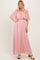 woman wearing a pink off-the-shoulder maxi dress with lace detailing on the bodice and flowy skirt