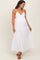 woman wearing a white maternity maxi dress with adjustable straps and tiered ruffles, showcasing a baby bump