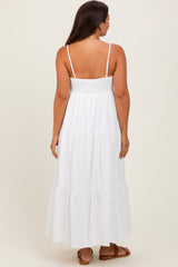 woman wearing a white maternity maxi dress with a smocked bodice and tiered skirt, view from the back
