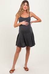 woman wearing a dark gray striped maternity dress and holding her baby bump