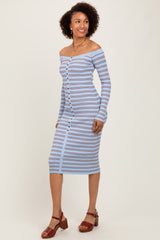woman wearing a light blue off-shoulder striped midi dress with button details and sandals