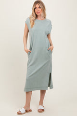 woman wearing a long, light green casual maxi dress with short sleeves and side pockets