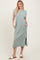 woman wearing a long, light green casual maxi dress with short sleeves and side pockets