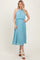 woman wearing a light blue pleated midi dress with a halter neck and flowy silhouette