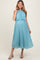 woman wearing a light blue pleated maternity dress with a high neckline and flowing skirt, showing her baby bump