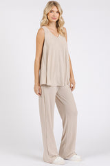 woman wearing a beige ribbed lounge set with a sleeveless top and wide-leg pants