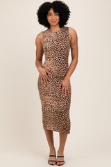 woman wearing a sleeveless leopard print midi dress and strappy black heels