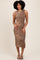 woman wearing a sleeveless leopard print midi dress and strappy black heels