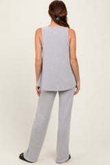 woman wearing a light gray ribbed tank top and matching wide-leg pants, viewed from the back