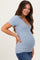 woman wearing a light blue ribbed maternity top with a v-neck and showing her baby bump
