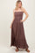 woman wearing a brown sleeveless maxi dress with ruffle hem and smocked bodice