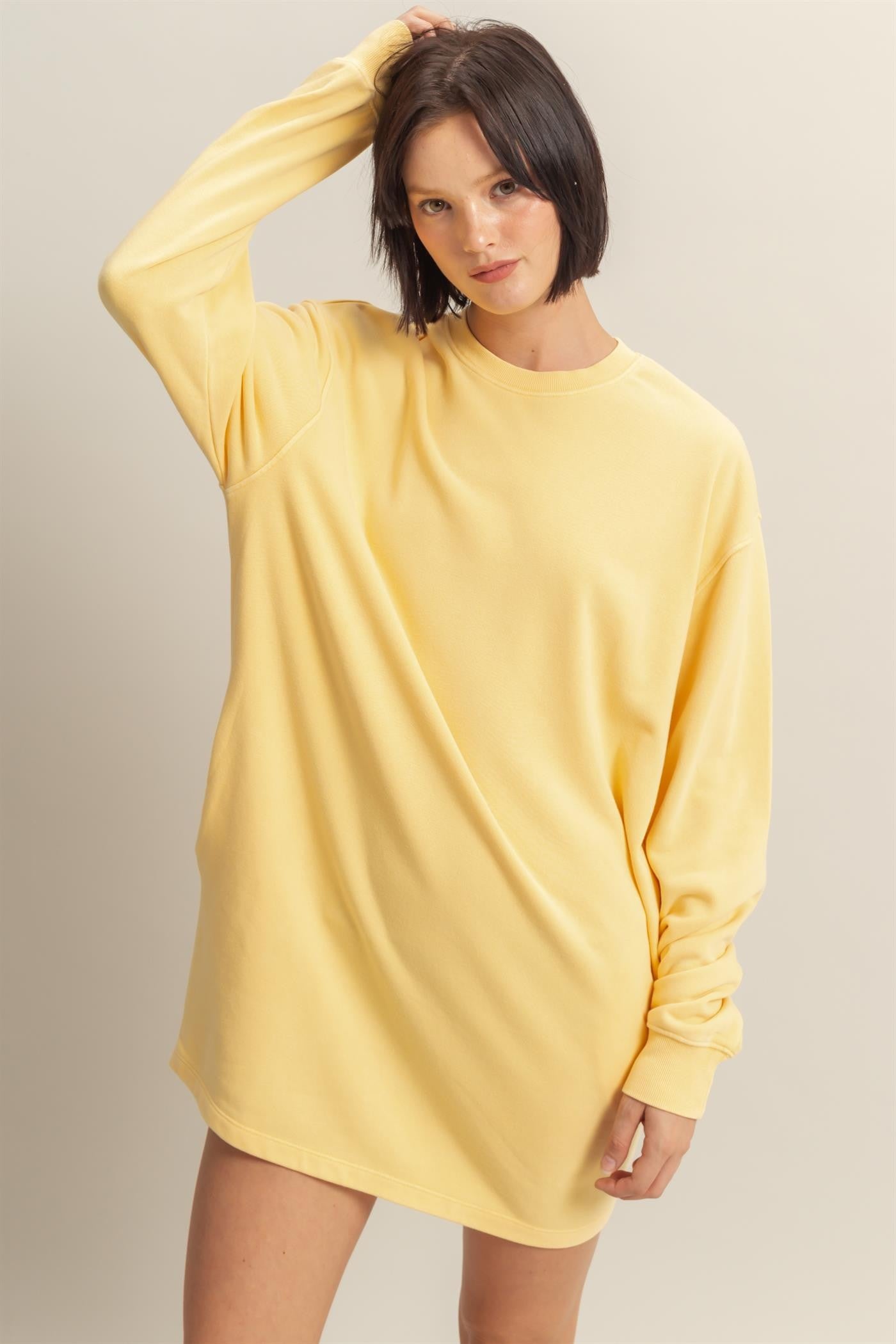woman wearing a yellow oversized long sleeve sweatshirt dress