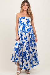 woman wearing a strapless blue and white floral maternity maxi dress