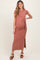 woman wearing a dusty rose maternity maxi dress with a twist detail and side slit, showing her baby bump