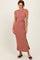 woman wearing a rose pink short sleeve maxi dress with a side tie and a thigh-high slit