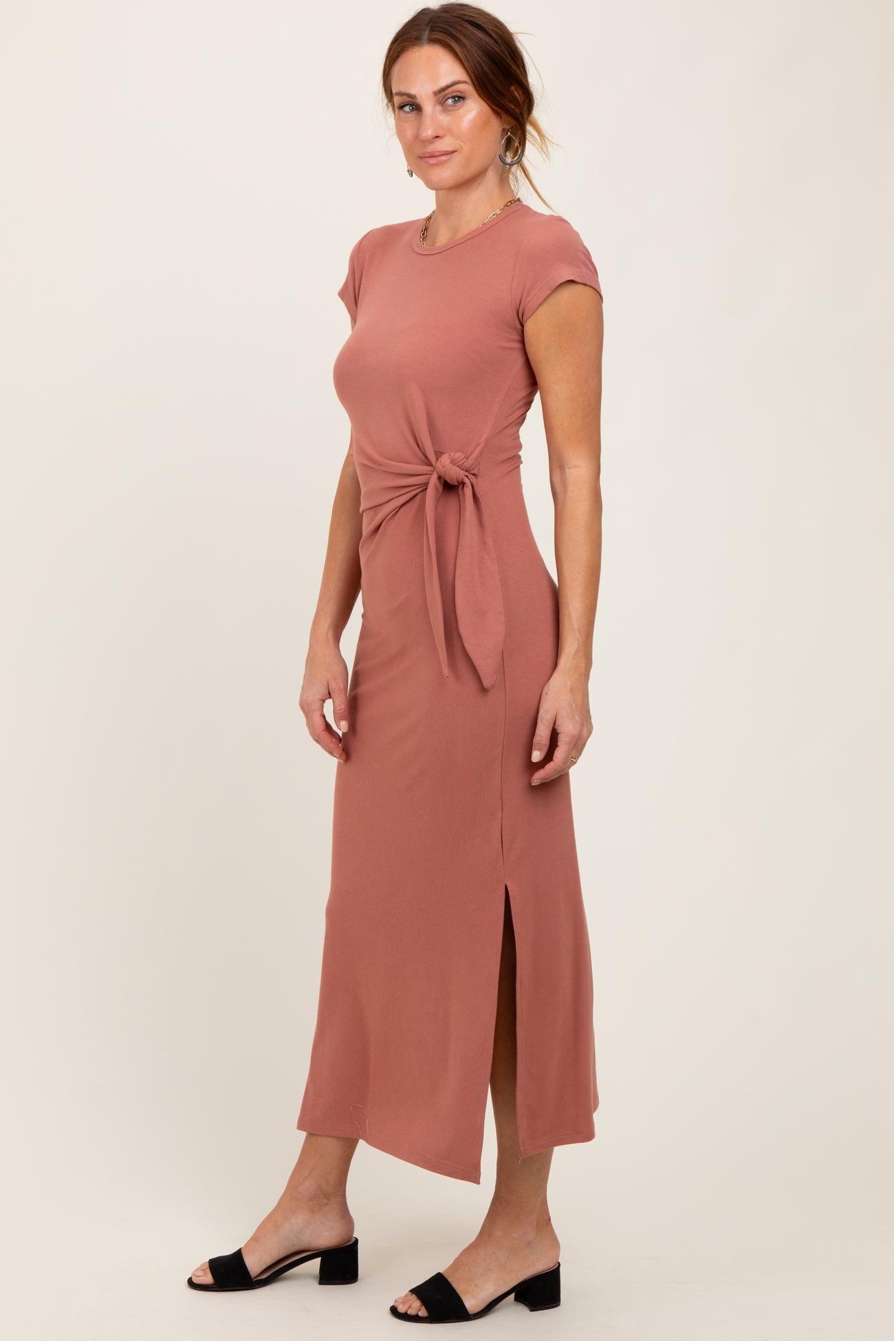 woman wearing a dusty rose maxi dress with a side tie and slit, styled with black sandals