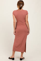 woman wearing a dusty rose cap sleeve midi dress with a slit at the side, viewed from the back