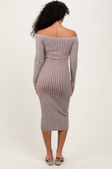 woman wearing a fitted off-the-shoulder striped midi dress in brown and beige, showing a form-fitting silhouette from the back