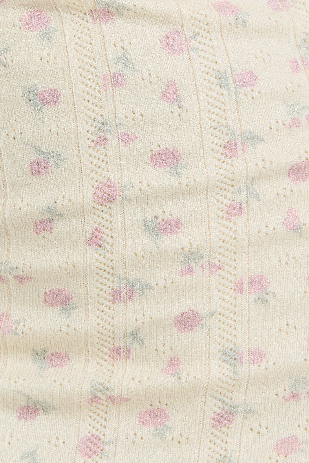 light beige fabric with a pink and blue floral pattern and delicate textured detailing