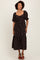 woman wearing a black floral midi dress with puff sleeves and a square neckline