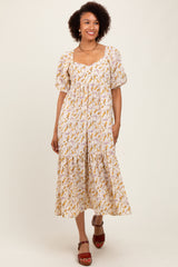 woman wearing a white floral midi dress with puff sleeves and a square neckline, standing and smiling