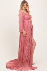 woman wearing a dusty rose lace maternity gown with off-the-shoulder sleeves and a flowing train, showing her baby bump