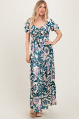 woman wearing a floral print maxi dress with short puff sleeves and a tie-front detail