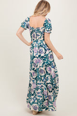 woman wearing a floral print maxi dress with puff sleeves and fitted bodice, showing the back view