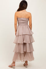 woman wearing a tiered mauve strapless dress with a smocked bodice and ruffled layers