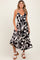 woman wearing a black and white abstract print maternity dress with a v-neck and spaghetti straps