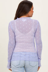 woman wearing a light purple long sleeve maternity top with heart patterns, viewed from the back