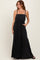 woman wearing a black tiered maxi dress with adjustable straps and pockets