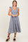 woman wearing a navy blue and white gingham tiered midi dress with ruffle straps and a square neckline
