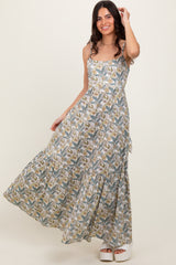 woman wearing a floral patterned maxi dress with a fitted bodice and tiered skirt