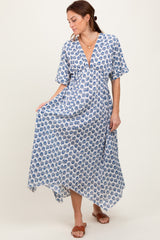 woman wearing a blue and white floral maxi dress with a deep v-neck and short sleeves