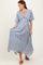 woman wearing a blue and white floral maxi dress with a deep v-neck and short sleeves