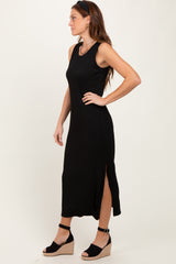 woman wearing a black sleeveless maxi dress with side slits and wedge sandals