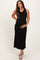 woman wearing a black sleeveless maternity maxi dress and holding her baby bump