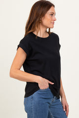 woman wearing a black short sleeve crew neck top with rolled cuffs and side slits, paired with blue jeans