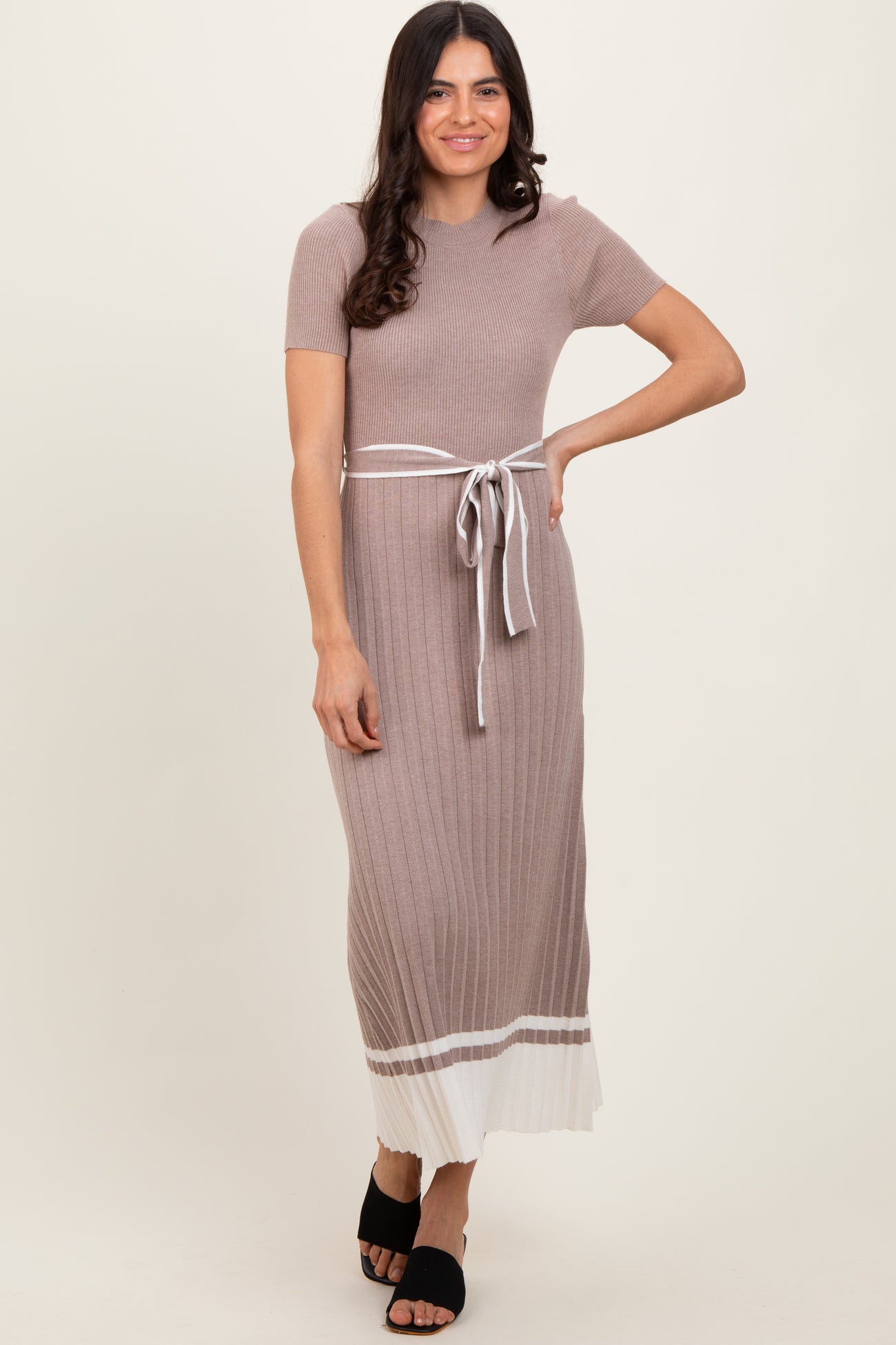woman wearing a short sleeve ribbed midi dress in taupe with a white tie waist and contrasting hem detail