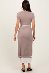 woman wearing a ribbed midi dress in taupe with a fitted design and white stripe detail at the hem