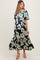 woman wearing a navy floral maternity dress with short sleeves and a tiered skirt, showcasing her baby bump
