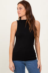 woman wearing a black sleeveless ribbed top with a mock neck and paired with blue jeans