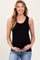 woman wearing a black ribbed sleeveless maternity top and holding her baby bump