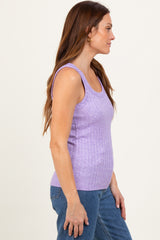 woman wearing a purple ribbed tank top with a fitted style and paired with blue jeans
