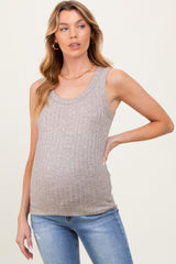 woman wearing a beige ribbed maternity tank top and showing her baby bump, paired with denim jeans