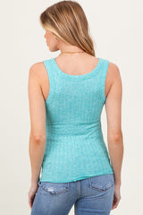 woman wearing a light blue maternity tank top with a ribbed texture, styled with blue jeans
