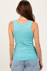 woman wearing a light turquoise ribbed tank top with a fitted silhouette and a scoop neckline